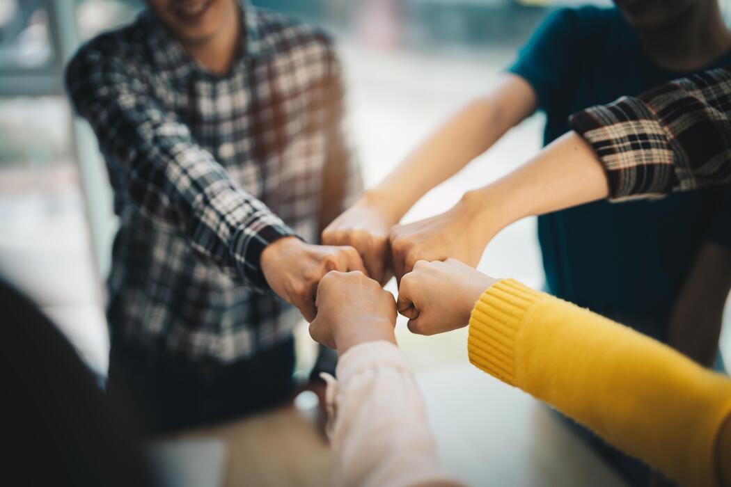 diverse group of asian business partner fist bump in modern office colleague partnership teamwork university student congratulation event job or mission accomplish concept free photo